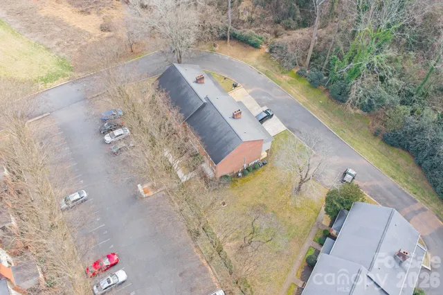 an aerial view of house with yard and swimming pool