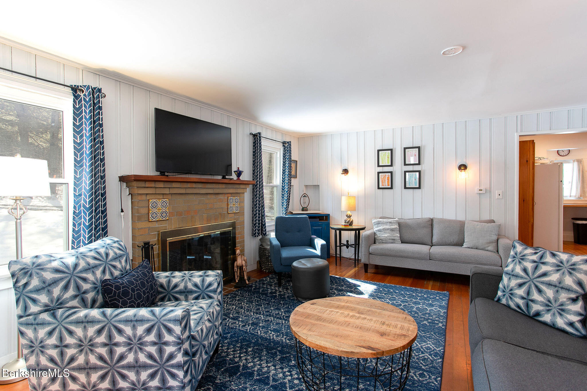 10 Elm Road Richmond, MA 01201 - Photo 22 of 32 a living room with furniture a fireplace and a flat screen tv