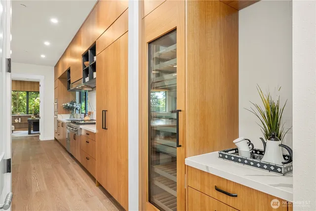 a spacious bathroom with a granite countertop sink a mirror and a shower