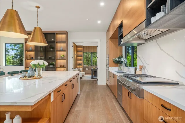 a kitchen with stainless steel appliances granite countertop a sink and stove
