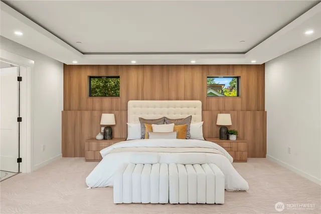 a bedroom with a bed and a wall painting