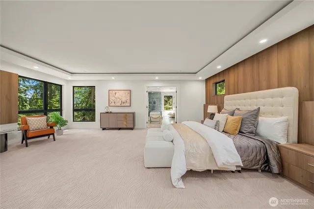 a spacious bedroom with a bed and large windows