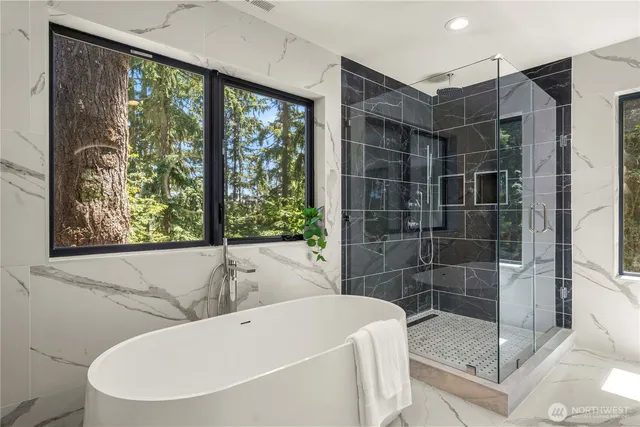 a bathroom with a bathtub and shower