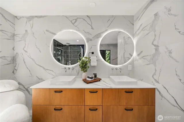 a bathroom with a granite countertop sink and mirror