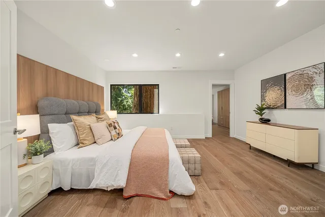 a spacious bedroom with a large bed and a couch