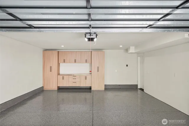 a view of a backyard with plants and large tree