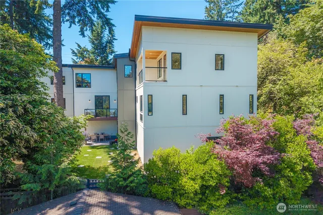 a view of a backyard with table and chairs and potted plants