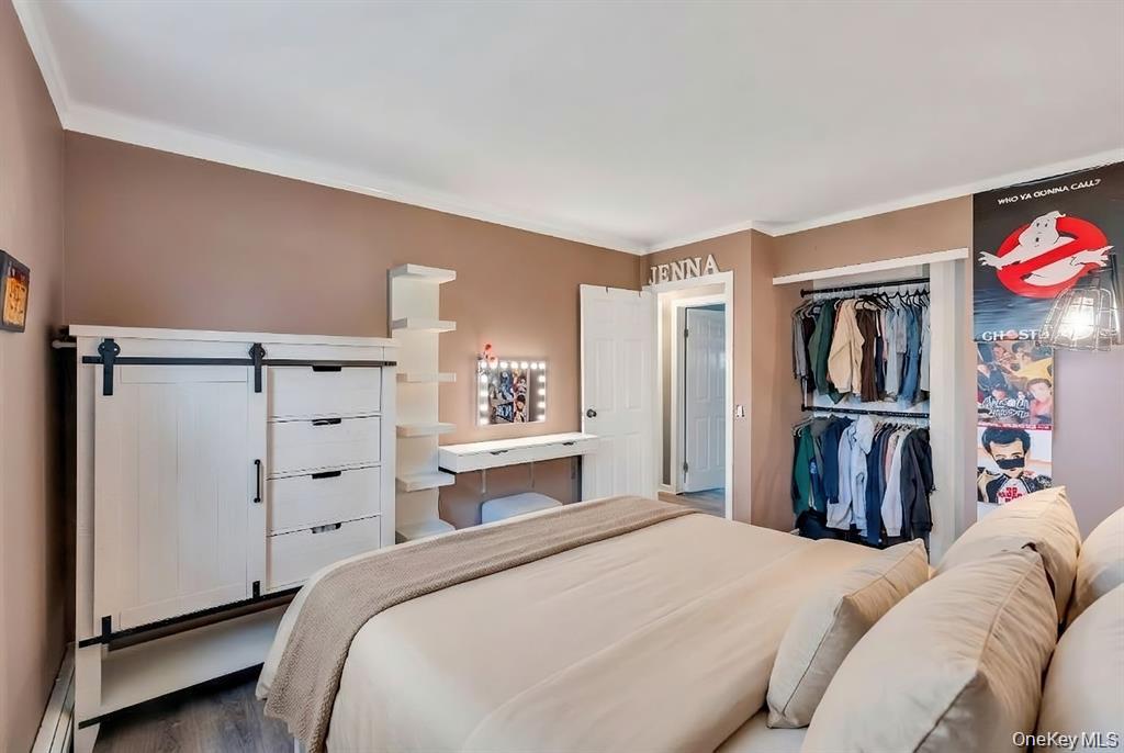 10 Ramblewood Road Ridge, NY 11961 - Photo 35 of 39 a bedroom with a large bed and a closet