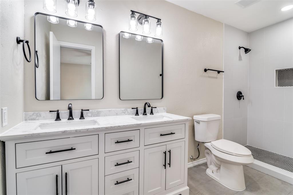 4017 Coryell Way Mesquite, TX 75150 - Photo 10 of 13 a bathroom with a toilet sink and mirror