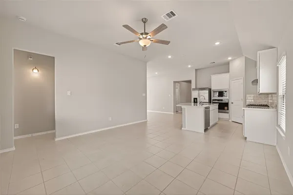 a view of kitchen with center island and stainless steel appliances