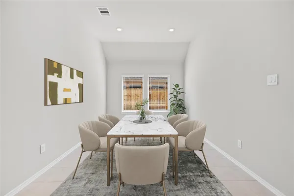 a dining room with furniture and window
