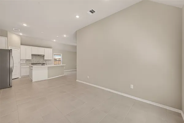a view of kitchen with refrigerator sink and cabinets