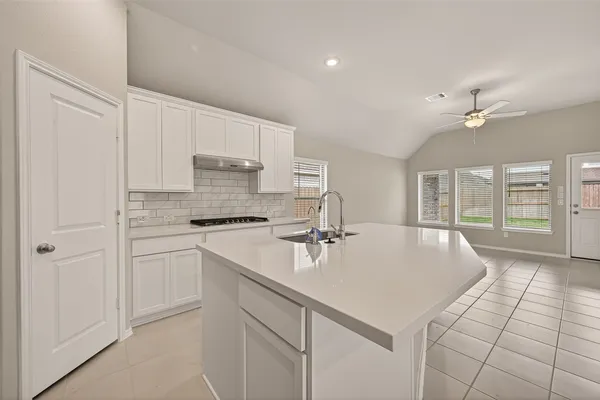 a kitchen with kitchen island white cabinets appliances and a center island