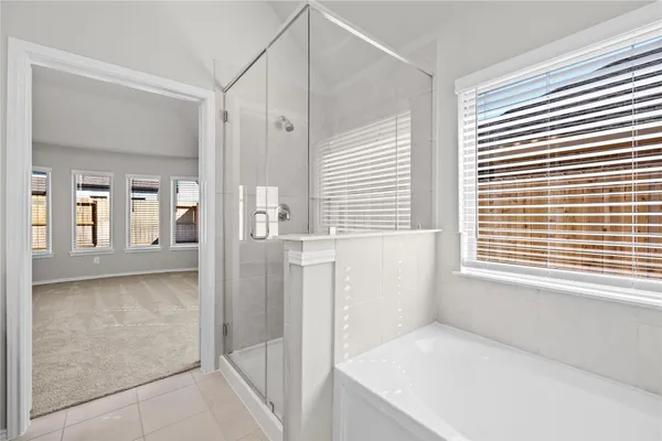 a bathroom with a bathtub and a shower