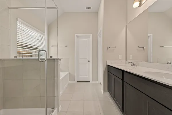 a bathroom with a double vanity sink and mirror