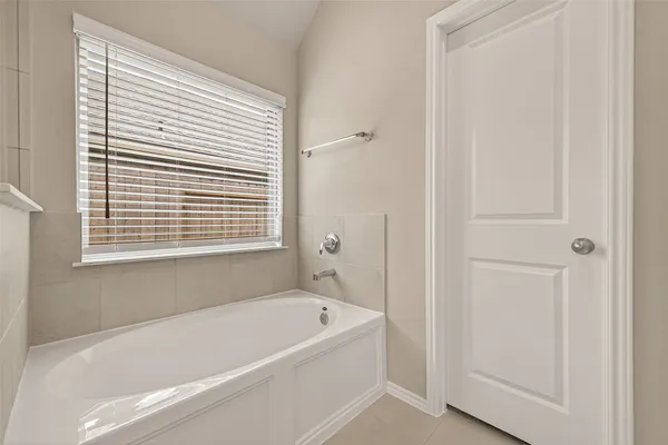 a white bath tub sitting next to a window