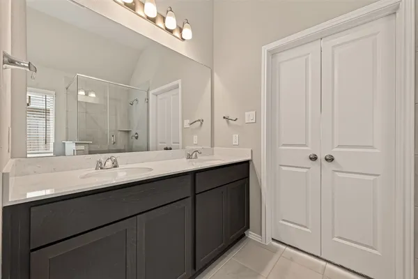 a bathroom with a double vanity sink and mirror
