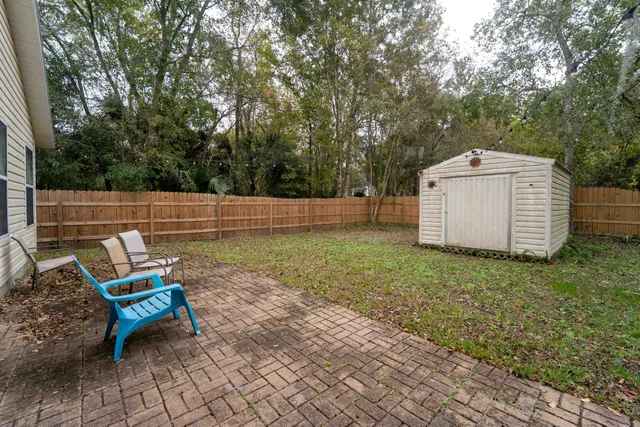 a backyard of a house with table and chairs