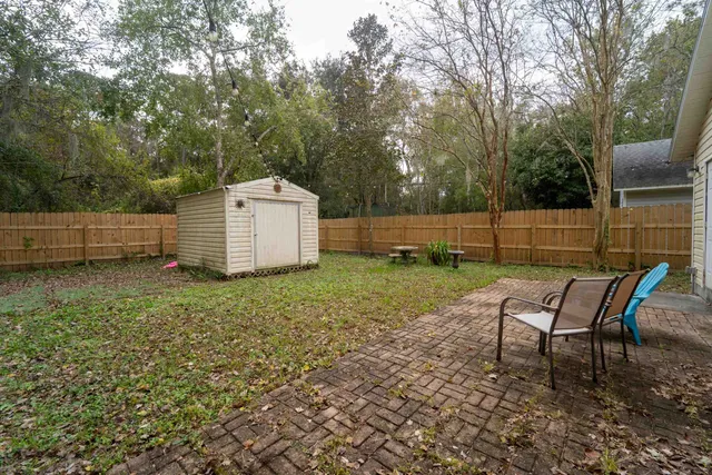 a backyard of a house with barbeque oven