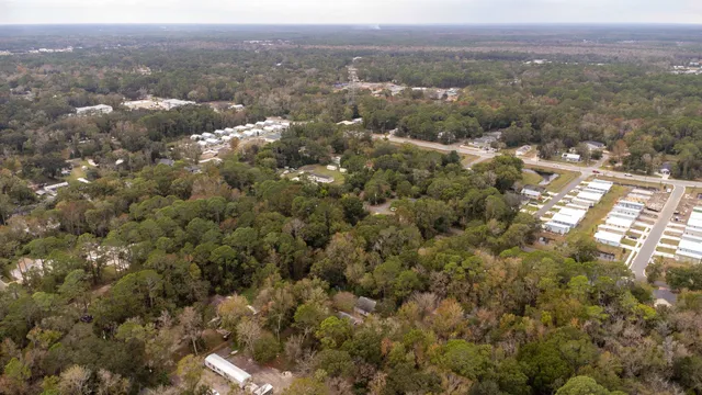 an aerial view of town with residential house and green space