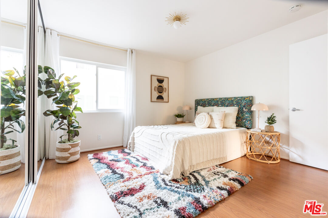 4804 Hollow Corner Road, Unit 125 Culver City, CA 90230 - Photo 16 of 43 a bedroom with a bed and a potted plant