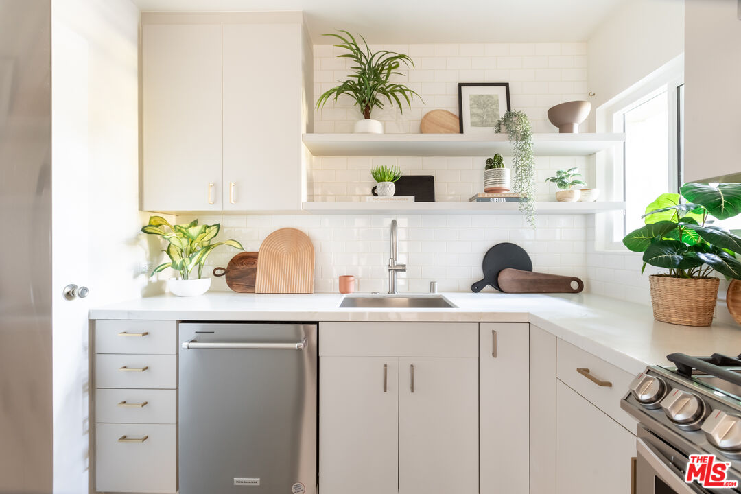 4804 Hollow Corner Road, Unit 125 Culver City, CA 90230 - Photo 2 of 43 a kitchen with white cabinets and sink