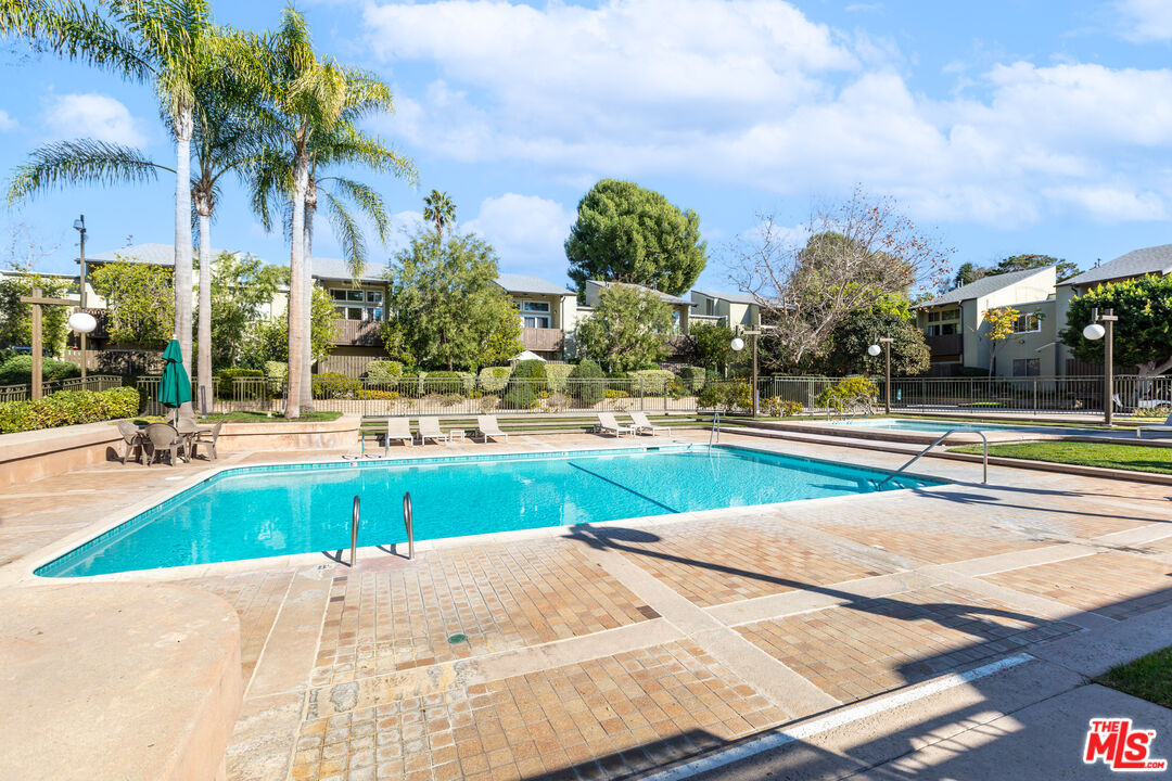 4804 Hollow Corner Road, Unit 125 Culver City, CA 90230 - Photo 4 of 43 a swimming pool with outdoor seating and yard