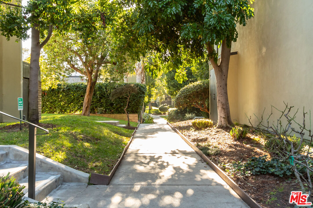 4804 Hollow Corner Road, Unit 125 Culver City, CA 90230 - Photo 5 of 43 a view of a garden with a bench in a patio