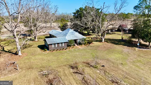 a view of a house with a yard covered in snow