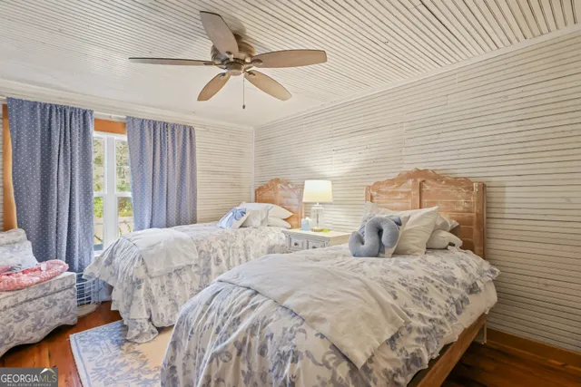 a bedroom with double bed and a window