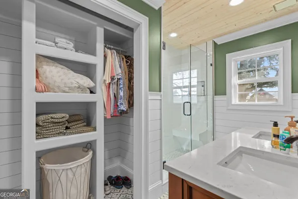 a bathroom with a sink a vanity and a shower