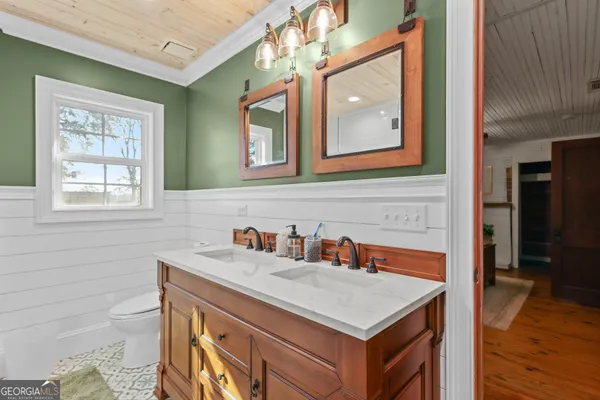 a bathroom with a sink a vanity and a mirror