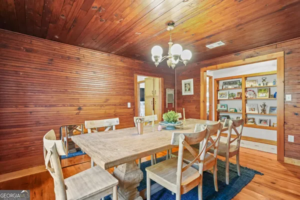 a view of a dining room with furniture wooden floor and chandelier