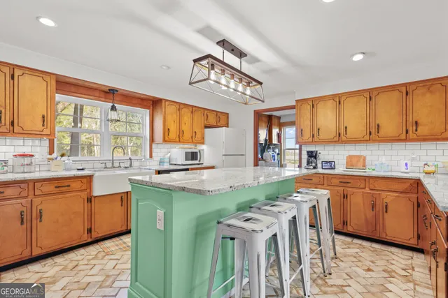 a kitchen with stainless steel appliances granite countertop a sink and cabinets
