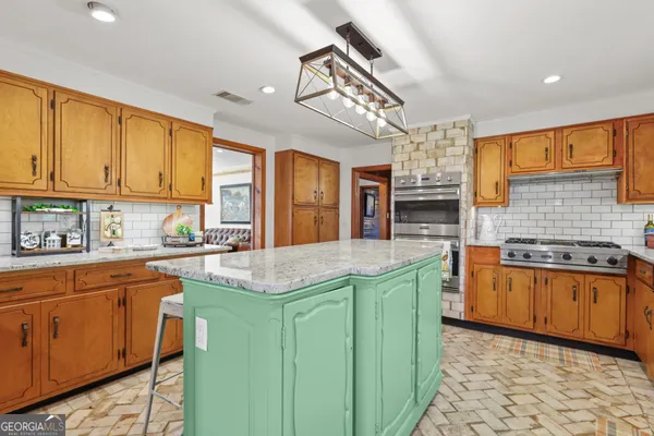 a kitchen with stainless steel appliances granite countertop a sink and cabinets