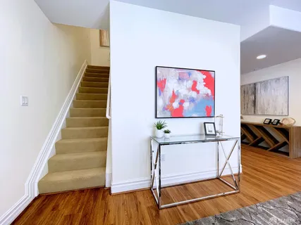 a view of a room with wooden floor and stairs