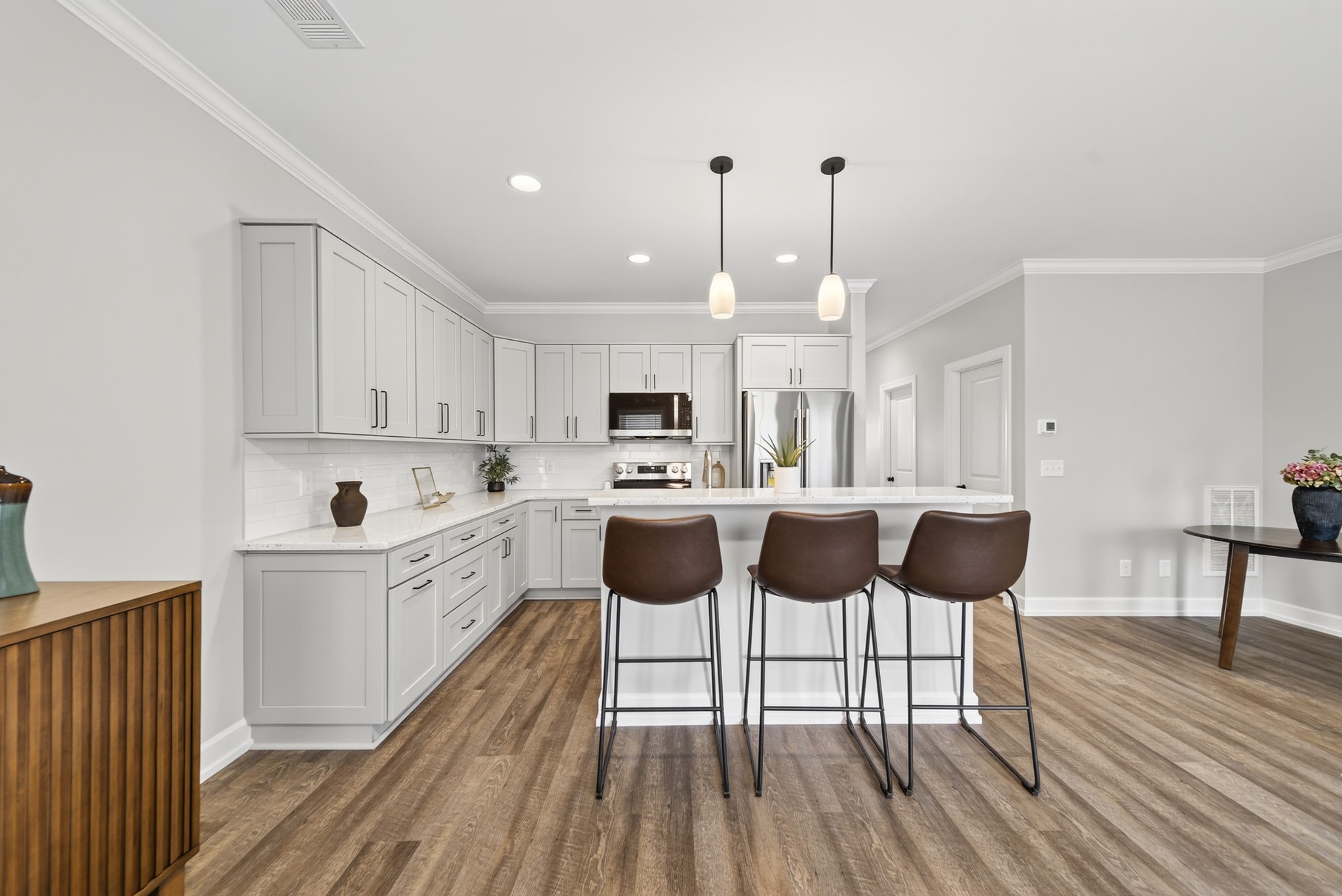 116 Maple View Road Lebanon, TN 37087 - Photo 7 of 21 a kitchen with a dining table chairs and white cabinets