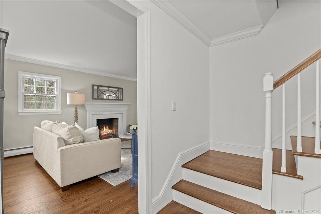 183 Frogtown Road New Canaan, CT 06840 - Photo 3 of 37 a living room with furniture and a fireplace