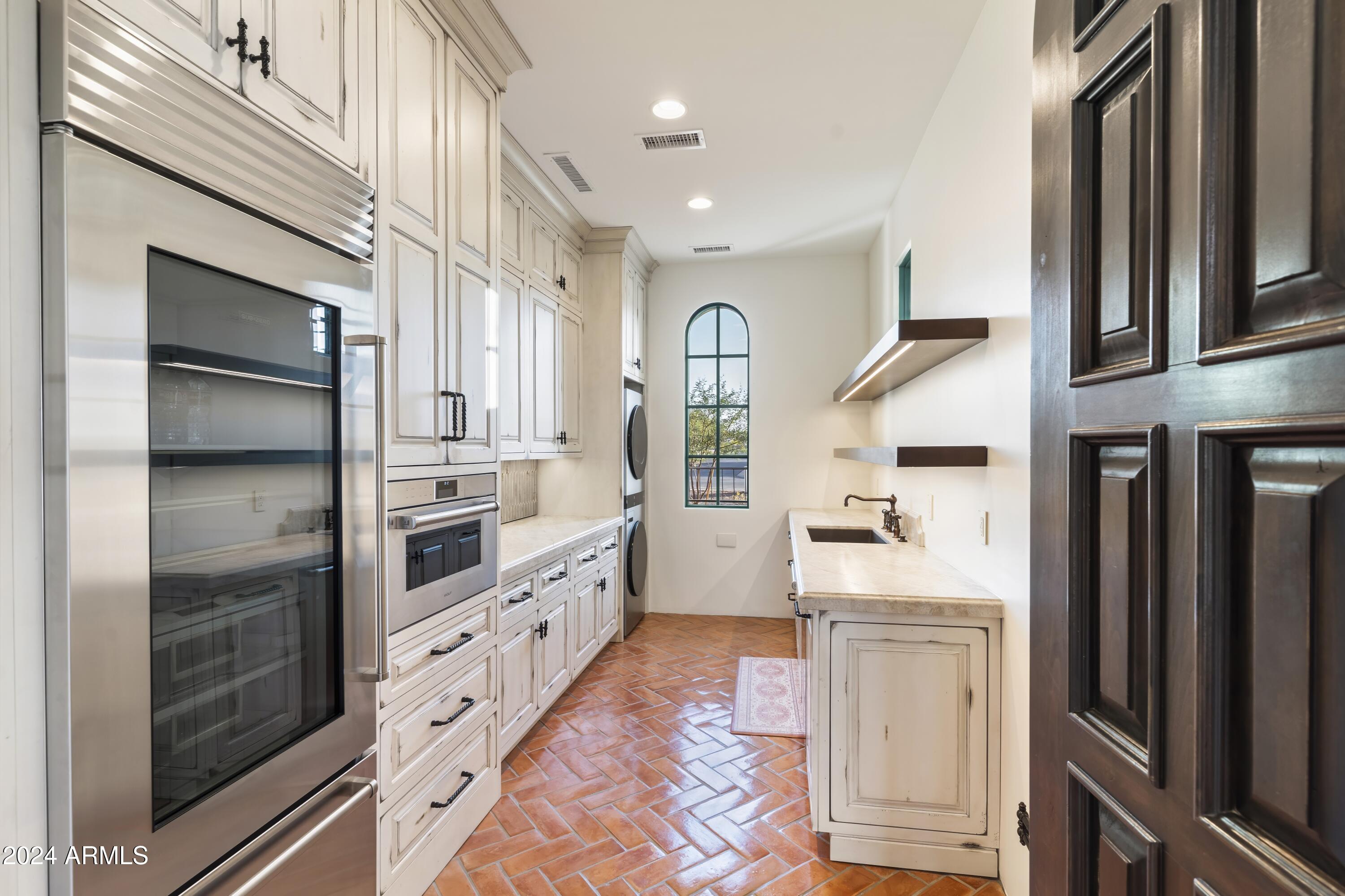 21868 East Stacey Road Queen Creek, AZ 85142 - Photo 21 of 146 a kitchen with stainless steel appliances a refrigerator and a stove