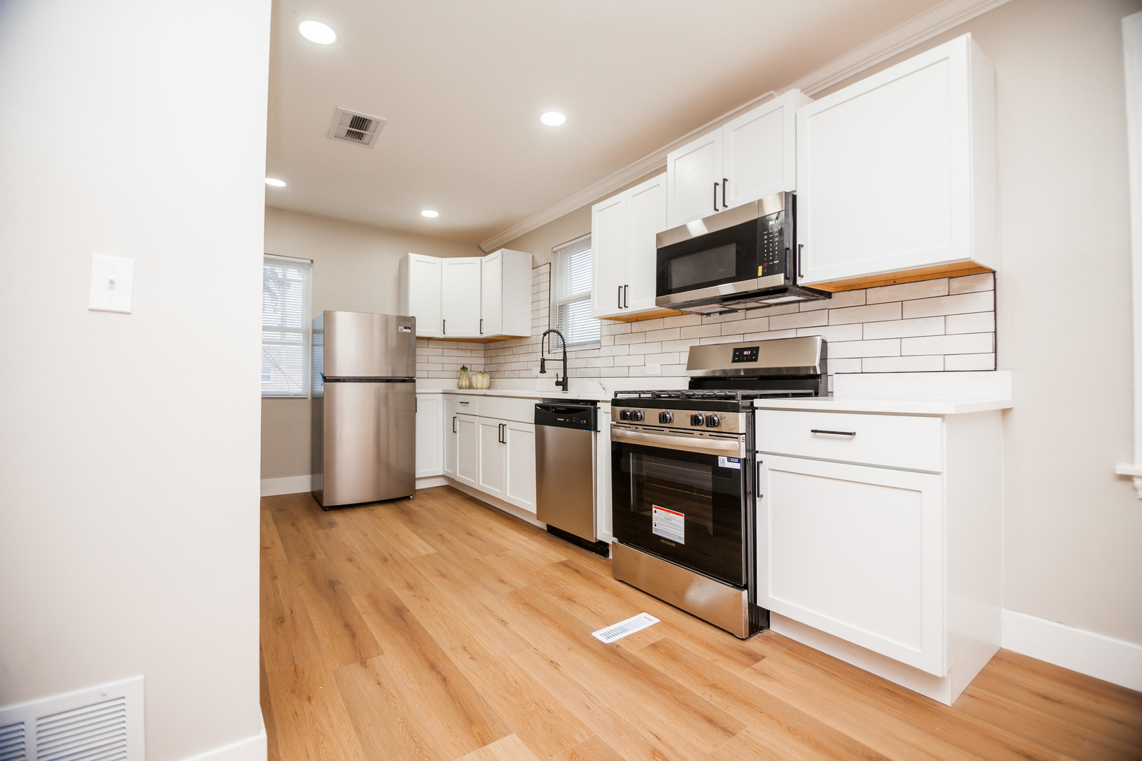 1156 West 102nd Street Chicago, IL 60643 - Photo 7 of 29 a kitchen with stainless steel appliances granite countertop a refrigerator stove a sink and a microwave