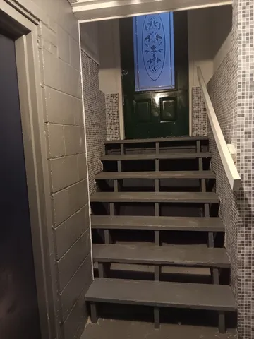 a view of a hallway with seating space