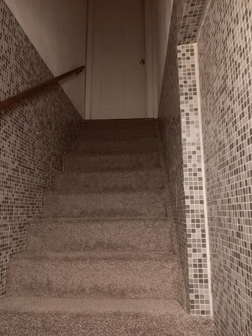 a kitchen with a stove and a chair