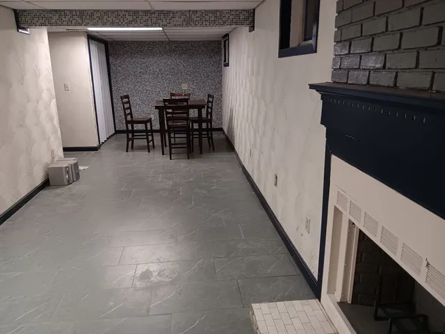 a white toilet sitting next to a shower