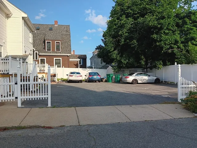 a view of city street with a parked car