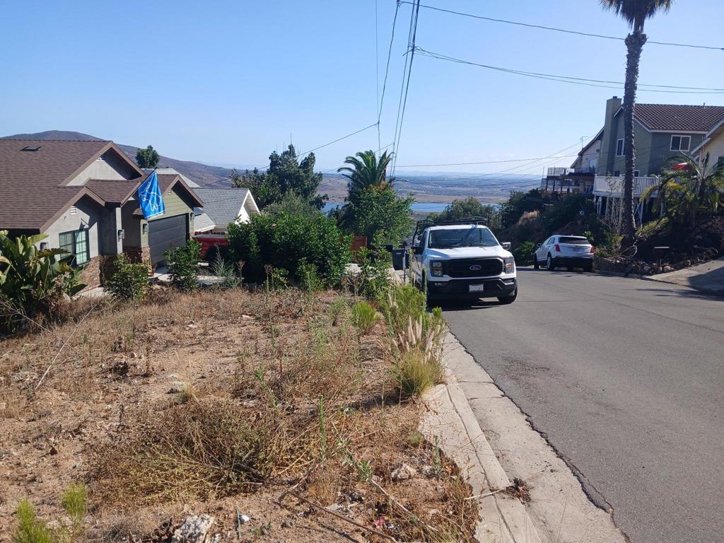 Undisclosed Address Spring Valley, CA 91977 - Photo 4 of 8 a front view of a house with a yard
