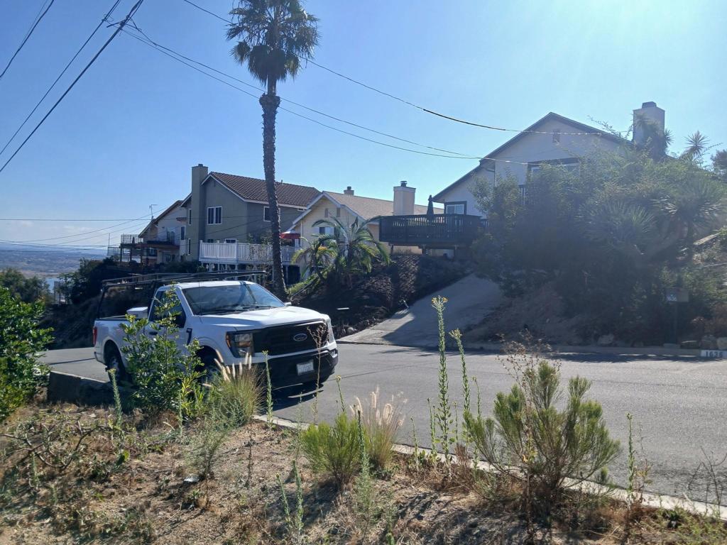 Undisclosed Address Spring Valley, CA 91977 - Photo 5 of 8 a view of a house with a yard and a large tree