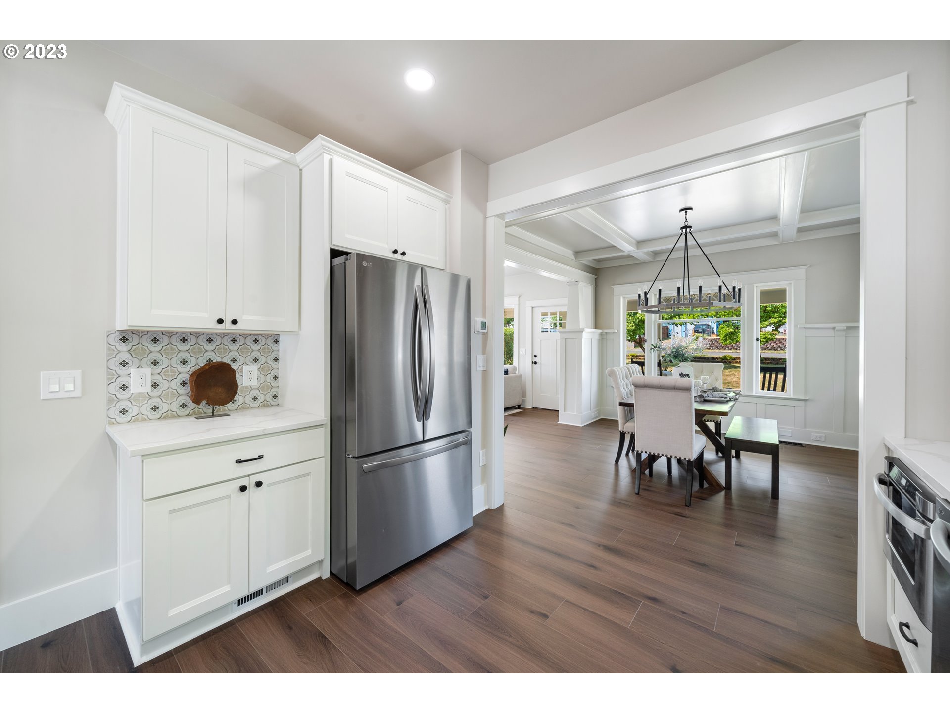914 Northwest 7th Avenue Camas, WA 98607 - Photo 10 of 26 a kitchen with stainless steel appliances granite countertop a refrigerator a microwave a stove and a dining table with wooden floor