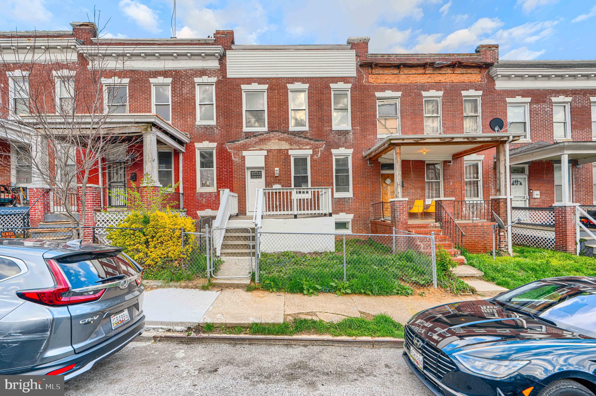 615 Linnard Street Baltimore, MD 21229 - Photo 27 of 28 a front view of a residential apartment building with a yard