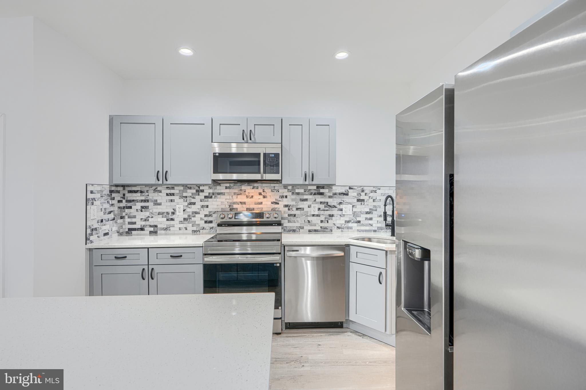 615 Linnard Street Baltimore, MD 21229 - Photo 3 of 28 a kitchen with stainless steel appliances granite countertop a stove a sink and a refrigerator