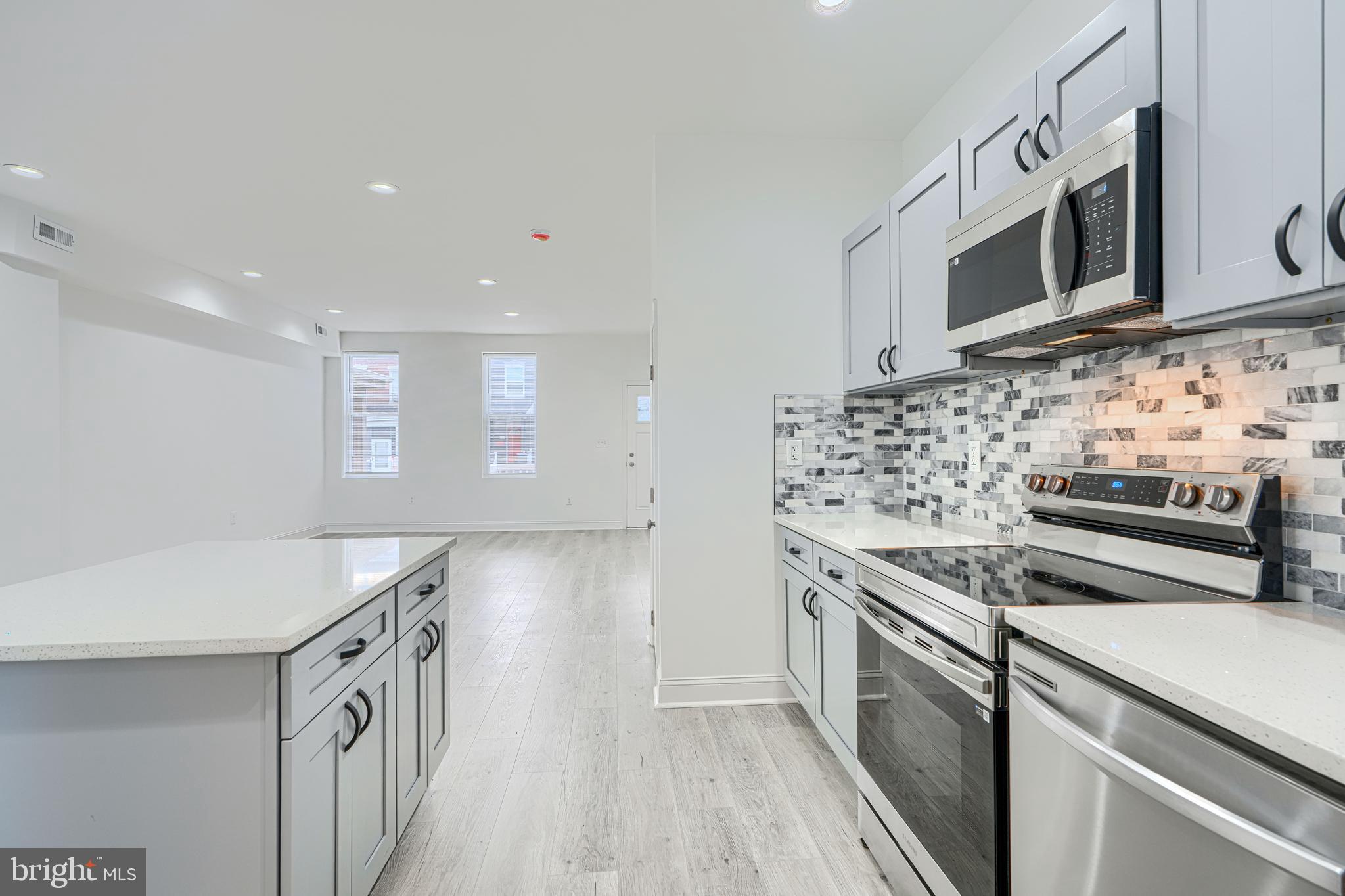 615 Linnard Street Baltimore, MD 21229 - Photo 5 of 28 a kitchen with stainless steel appliances a sink stove and microwave